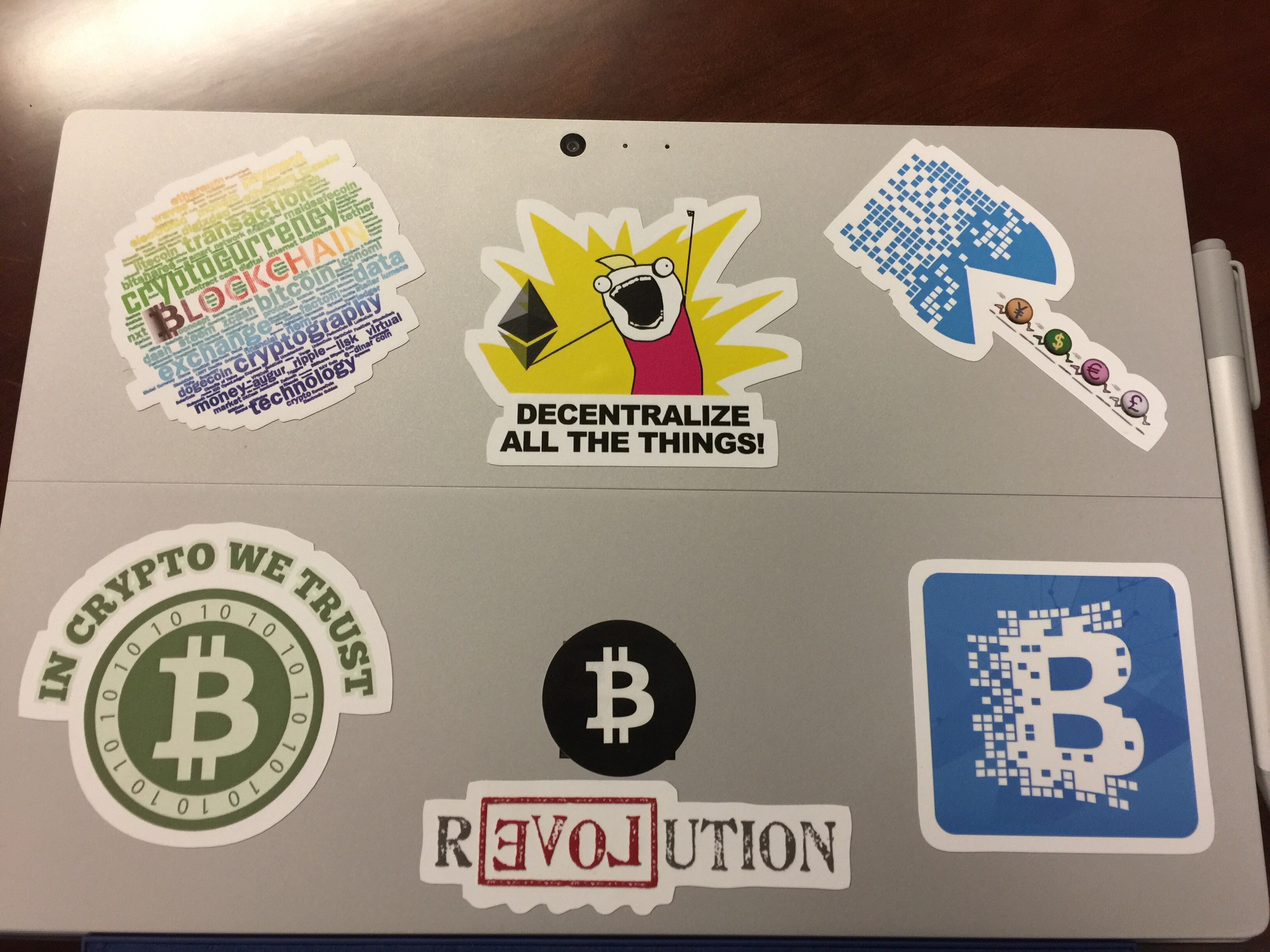 Cryptocurrency and blockchain stickers on a laptop